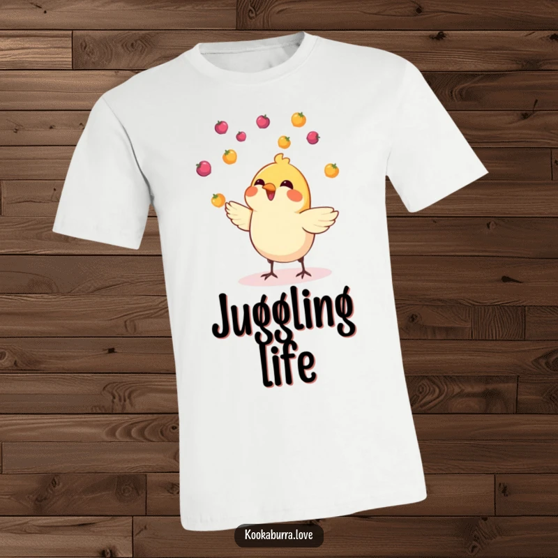 Funny t-shirt featuring a small, cheerful bird skillfully juggling multiple tiny, colorful berries tossed upwards.